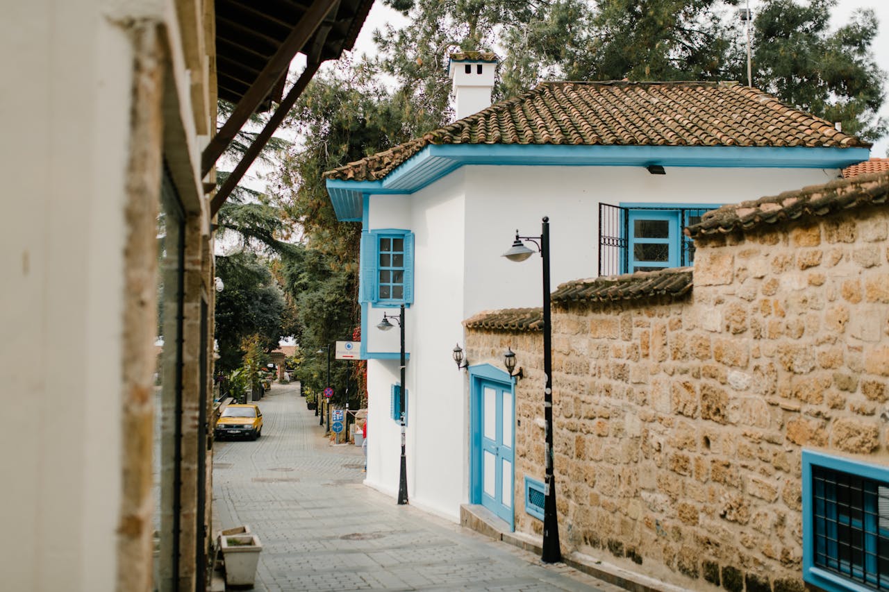 Tranquil alley with traditional architecture and stone walls in a peaceful residential area.